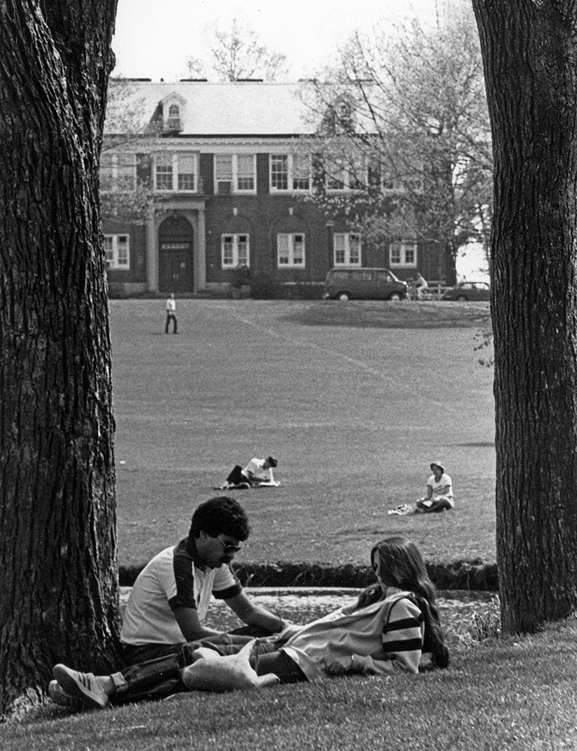 Students relaxing on a lawn.