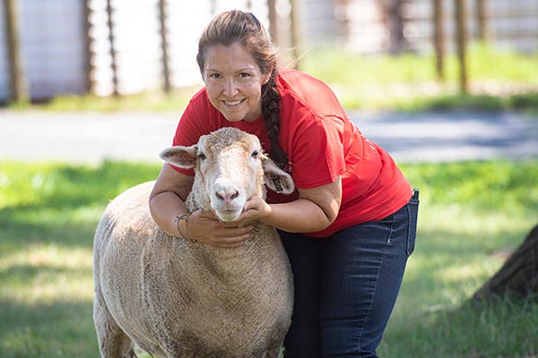 Rebecca Potosky holding a sheep.